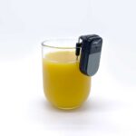 Liquid Level Indicator on the lip of a glass of orange juice