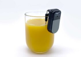 Liquid Level Indicator on the lip of a glass of orange juice