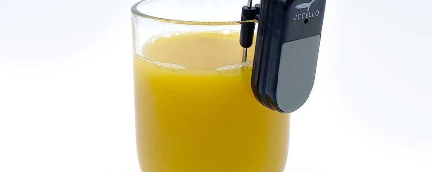 Liquid Level Indicator on the lip of a glass of orange juice