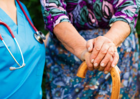 Nurse with elderly woman living with Parkinson's