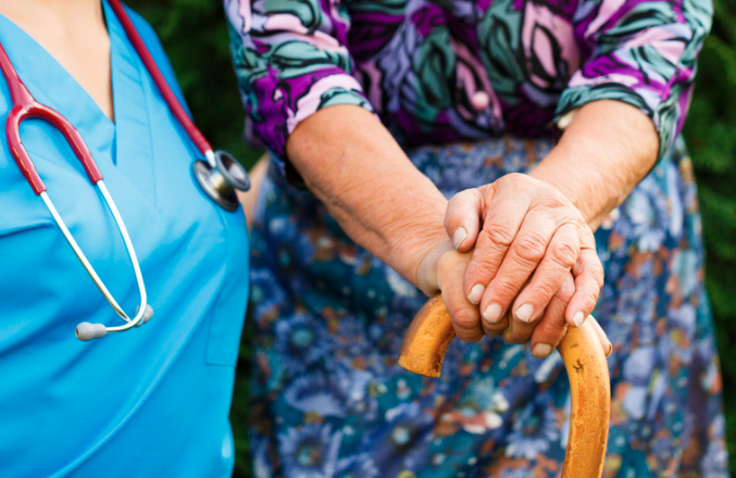 Nurse with elderly woman living with Parkinson's