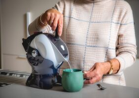 Elderly woman using the lightweight easy pour Uccello Kettle to make a cup of tea