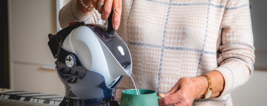 Elderly woman using the lightweight easy pour Uccello Kettle to make a cup of tea