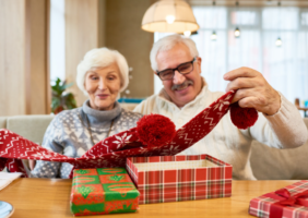 Grandparents opening Christmas presents