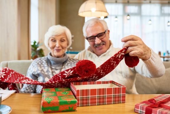 Grandparents opening Christmas presents