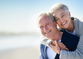 Elderly couple walking along the beach