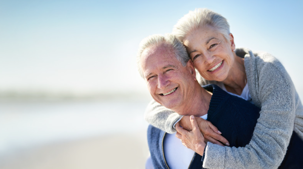 Elderly couple walking along the beach