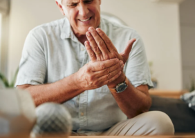 Elderly man with joint pain in his hand
