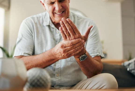 Elderly man with joint pain in his hand