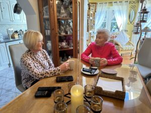 Daughter and mother enjoying a cup of tea together at home