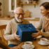 Adult woman giving a gift to an elderly man.