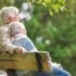 Elderly couple sitting on a park bench on a warm summers day