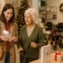 Adult daughter and older mother browsing together, looking at products displayed as gift ideas.