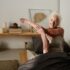 Elderly woman in bed and doing her morning stretches