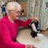 Elderly woman pouring the Uccello Kettle to make a cup of tea in her kitchen