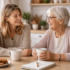 Elderly mother and adult daughter enjoying a cup of tea together and a chat